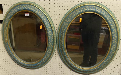 Lot 1137 - A pair of floral painted oval wall mirrors,...