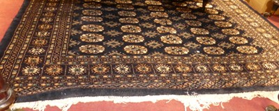 Lot 1140 - A Persian woollen deep navy ground Bokhara rug,...