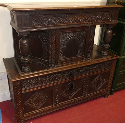 Lot 1143 - A joined and relief carved oak court cupboard,...