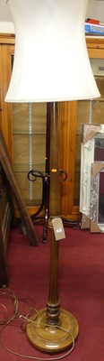 Lot 1150 - A turned walnut standard lamp with shade
