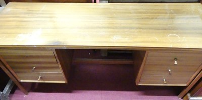 Lot 1189 - A 1960s walnut kneehole long dressing table,...