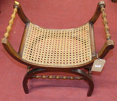 Lot 1197 - A walnut and cane inset X-frame dressing stool,...