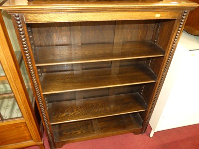 Lot 1220 - A 1920s beaded oak freestanding open bookshelf,...