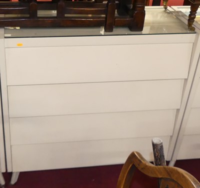 Lot 1224 - Three white painted 1960s bedroom chests, each...