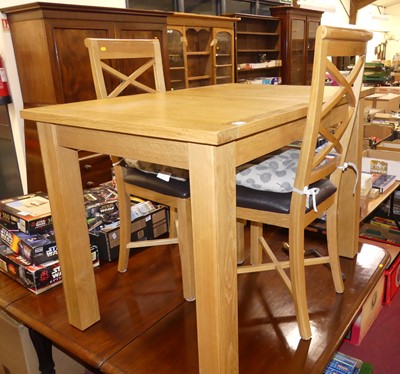 Lot 1257 - A contemporary blond oak extending dining...