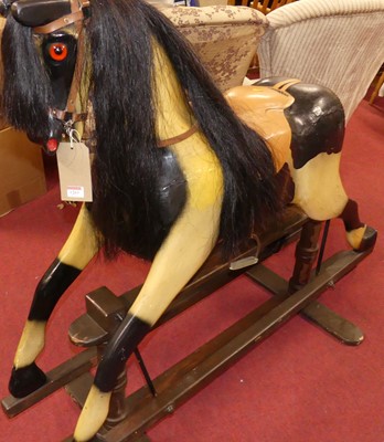Lot 1263 - A painted dapple grey rocking horse, with tan...