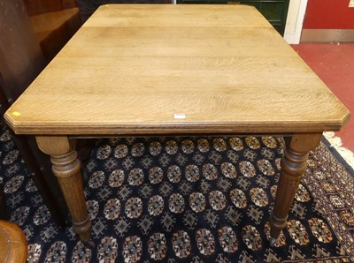 Lot 1314 - An Edwardian oak extending dining table,...