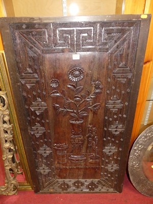 Lot 1317 - A Chinese stained hardwood relief carved wall...