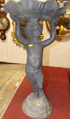 Lot 1321 - A lead bird bath, the scalloped shell raised...