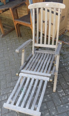 Lot 1328 - A pair of contemporary slatted teak folding...