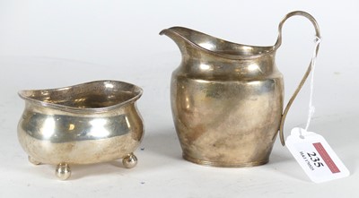 Lot 235 - A George V silver cream jug, of helmet shape,...