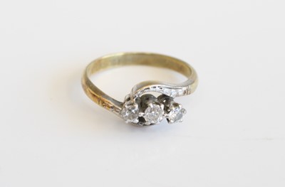 Lot 297 - An 18ct gold diamond three stone ring, the...