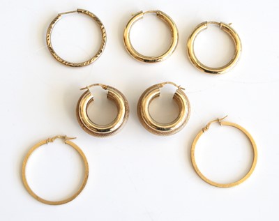 Lot 310 - Three pairs of modern 9ct hollow gold hoop...