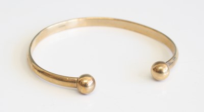 Lot 311 - A modern 9ct gold cuff bangle, sponsor AJ Ltd,...