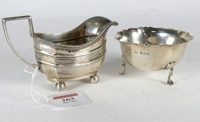 Lot 263 - A George V silver cream jug having a gadrooned...
