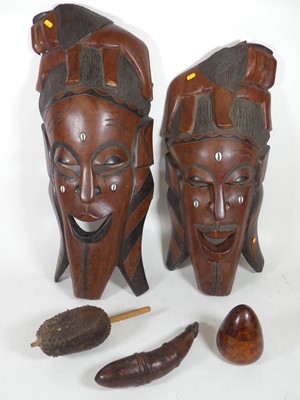 Lot 464 - A near-pair of African carved hardwood and...