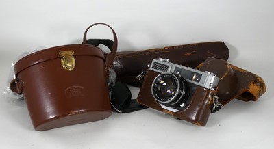 Lot 483 - A Konica camera in fitted brown leather case;...