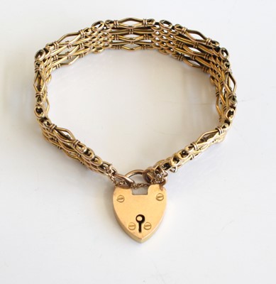 Lot 335 - A 9ct gold gate link bracelet having heart...