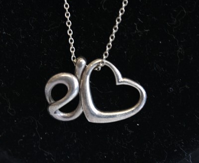 Lot 347 - A white metal pendant on fine trace link neck...
