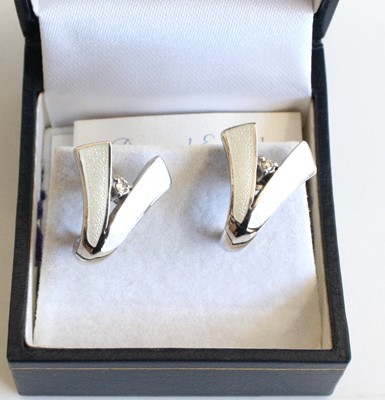 Lot 348 - A pair of silver enamel and diamond point set...