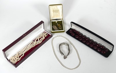 Lot 407 - A simulated pearl two-strand necklace, having...