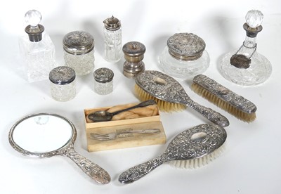 Lot 455 - A collection of silver dressing table jars...