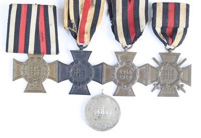 Lot 3044 - A German Cross of Honour with swords, together...