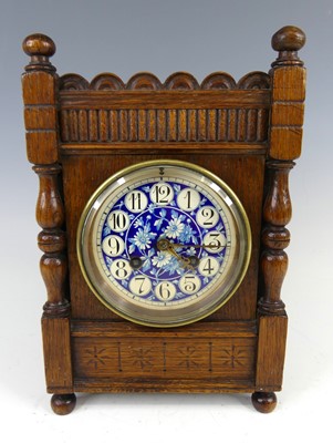 Lot 175 - An Aesthetic Movement oak mantel clock, in the...