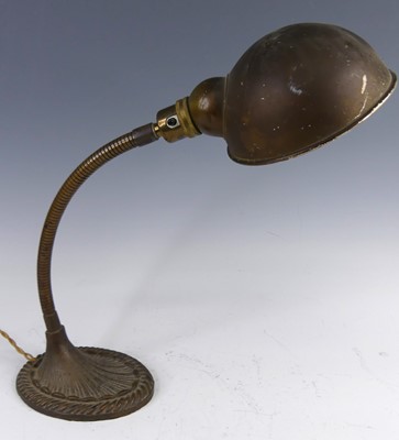 Lot 180 - An Art Deco brass desk lamp, the domed shade...