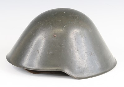 Lot 3101 - An East German M56 / 76 steel combat helmet,...