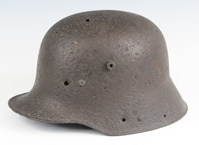 Lot 3104 - A German M16 steel helmet shell, in pitted...