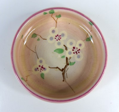 Lot 25 - A 1930s Clarice Cliff pottery circular squat...