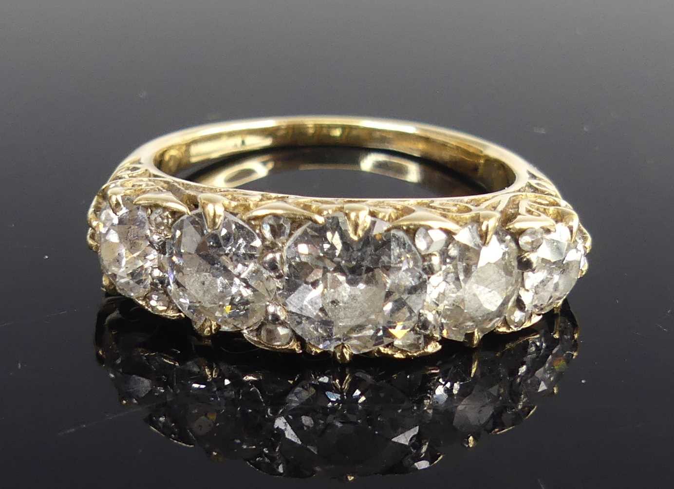 Lot 2100 - A yellow metal diamond half eternity ring,...