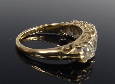 Lot 2100 - A yellow metal diamond half eternity ring,...