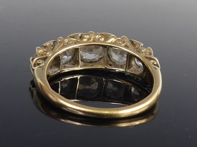 Lot 2100 - A yellow metal diamond half eternity ring,...