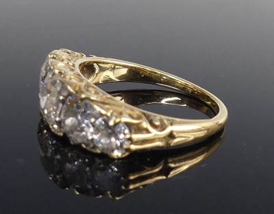 Lot 2100 - A yellow metal diamond half eternity ring,...
