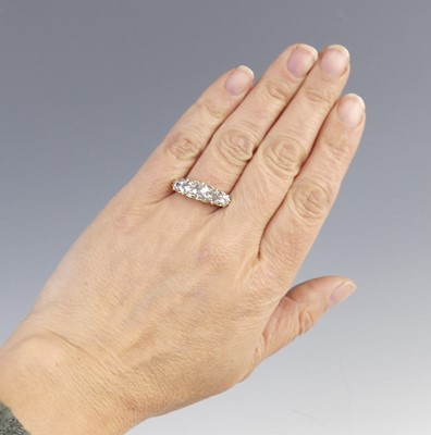 Lot 2100 - A yellow metal diamond half eternity ring,...