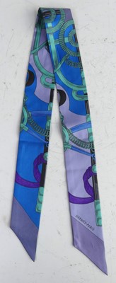 Lot 145 - Hermès - a Twilly silk scarf, typically...