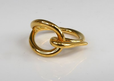 Lot 143 - Hermès - a gold plated scarf ring, with...
