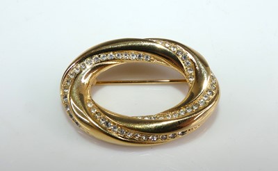 Lot 142 - Christian Dior - a gold plated oval brooch,...