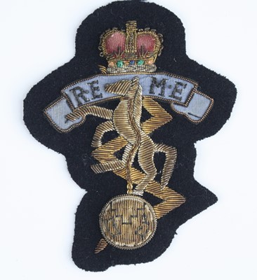 Lot 3237 - An REME bullion badge, together with three...