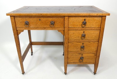Lot 356 - An Arts & Crafts oak single pedestal kneehole...