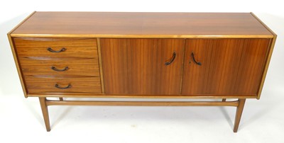Lot 381 - A 1960s British walnut sideboard, having twin...