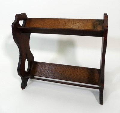 Lot 352 - An Arts & Crafts oak table two-tier book...