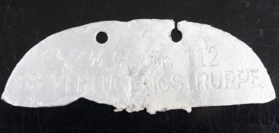 Lot 3301 - A German identity disc, the half section alloy...