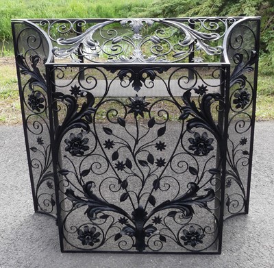 Lot 2287 - An Arts & Crafts wrought iron sparkguard, of...