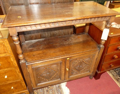 Lot 1217 - An early 20th century oak buffet, raised on...