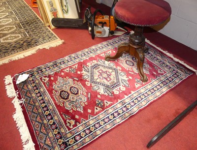 Lot 1074 - A Persian woollen red ground Tabriz hall rug,...