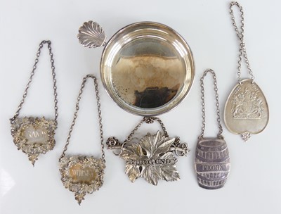 Lot 2102 - A collection of five silver decanter collars,...