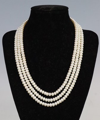 Lot 289 - A three-row freshwater pearl necklace, the...